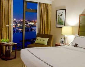 Spacious king bedroom with work station at Pacific Gateway Hotel Vancouver Airport.