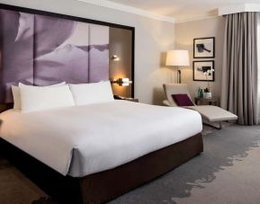 Delux king bed with TV and business desk at Pullman Miami Airport.