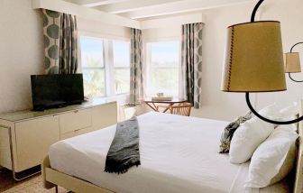 Spacious king bedroom with TV and work station at The Broadmore Miami Beach.