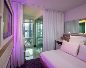 Spacious king bedroom with TV and work station at YOTEL New York.