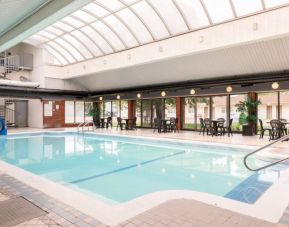 The hotel’s indoor pool features a slide, and has nearby tables and chairs.