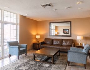 Comfortable seating area in the hotel lobby, with lamps and coffee tables.