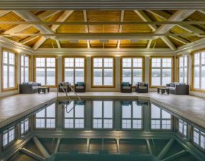 The hotel’s indoor pool has armchairs and sofas nearby.