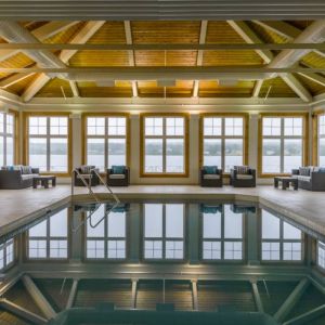 The hotel’s indoor pool has armchairs and sofas nearby.