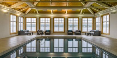 The hotel’s indoor pool has armchairs and sofas nearby.