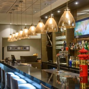 The hotel’s bar has tall stools, art on the wall, and a broad selection of beverages.