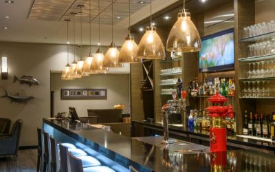 The hotel’s bar has tall stools, art on the wall, and a broad selection of beverages.