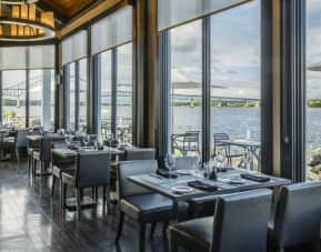 Rodd Miramichi River’s on-site restaurant has hard floors and tables with waterfront views.