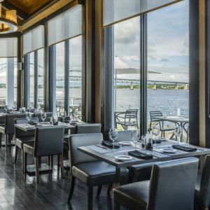 Rodd Miramichi River’s on-site restaurant has hard floors and tables with waterfront views.