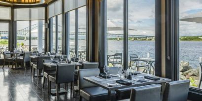 Rodd Miramichi River’s on-site restaurant has hard floors and tables with waterfront views.
