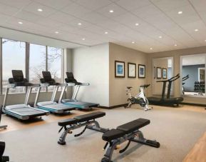 Fully equipped fitness center with window view at the Embassy Suites by Hilton Toronto Airport.