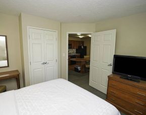 Candlewood Suites Meridian guest room featuring TV and a kitchenette area.