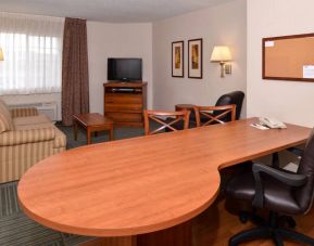 An in-room workspace at Candlewood Suites Meridian, including desk and chair.