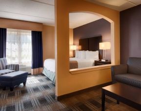 Best Western Hartford Hotel & Suites guest room, featuring bed, armchair, and sofa.