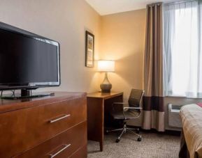 The Staten Island Inn guest room, including TV and a workspace desk and chair.