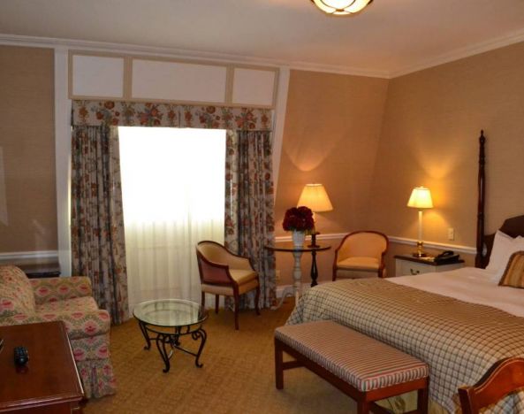 Guest room in The Wall Street Inn, including chairs and television.