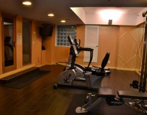 The hotel fitness center has exercise machines and a television.