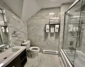 Spacious guest bathroom with shower at Skylaranna Hotel and Resort.