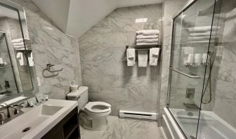 Spacious guest bathroom with shower at Skylaranna Hotel and Resort.