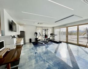 Fitness center with treadmill and weights at Skylaranna Hotel and Resort.