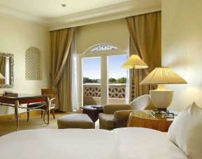 Delux king bed with TV at Grand Hyatt Muscat.