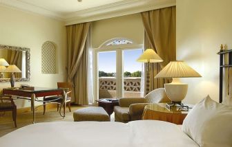 Delux king bed with TV at Grand Hyatt Muscat.