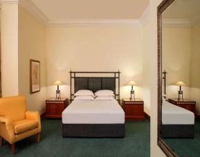 Spacious king bedroom with TV and work station at Grand Hyatt Muscat.