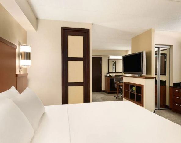 Delux king bed with TV and business desk at Hyatt Place Baltimore/Owings Mills.