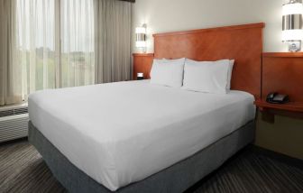 Spacious king bedroom with TV at Hyatt Place Louisville - East.