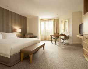 Delux king bed with TV and business desk at Hyatt Regency Perth.