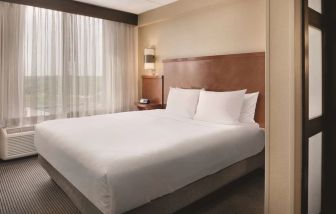 Spacious king bedroom with TV at Hyatt Place Chicago/Hoffman Estates.