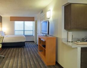 Spacious king bedroom with TV and work space at Hyatt House Houston / Galleria.