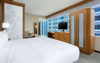 Spacious king bedroom with TV and work space at Hyatt Place Chicago Downtown/The Loop.