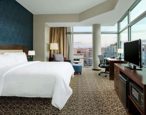 Delux king bed with TV and business desk at Hyatt Place DC Georgetown West End.