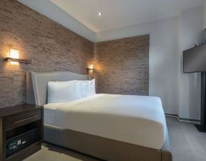 Spacious king bedroom with TV at Hyatt Herald Square New York.