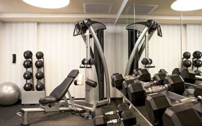 The Hotel 48LEX New York’s fitness center, with weights and exercise machinery.