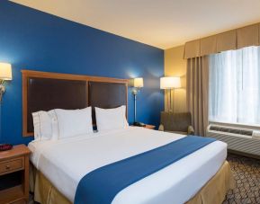 At guest room in the Holiday Inn Express New York City – Chelsea, with large bed and window.