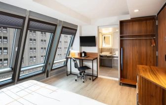 Guest room in La Quinta Times Square South, with workspace and ensuite bathroom.