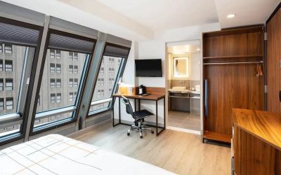Guest room in La Quinta Times Square South, with workspace and ensuite bathroom.