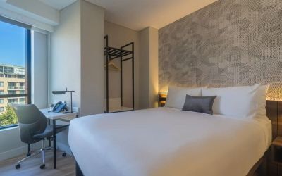 King bedroom with work space and natural light at Hotel Kith.