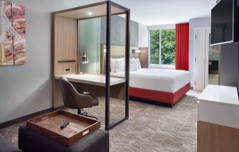 Spacious king room with TV and business desk at SpringHill Suites Atlanta Northwest.