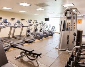Fitness center with treadmills at Embassy Suites By Hilton West Palm Beach Central.