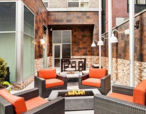 Cozy coworking space with fire pit at Hilton Garden Inn New York/West 35th Street.