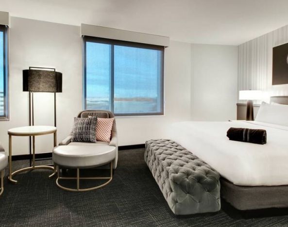 Spacious king bed with natural light at The Rose Hotel Chicago O’Hare, Tapestry Collection By Hilton.