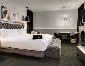 Spacious delux room with TV and seating area at The Rose Hotel Chicago O’Hare, Tapestry Collection By Hilton.