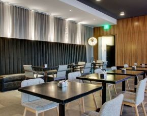 Comfortable coworking space and dining area at The Rose Hotel Chicago O’Hare, Tapestry Collection By Hilton.