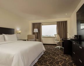 Delux king bed with TV and business desk at Doubletree By Hilton Toluca.