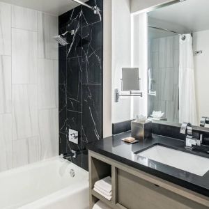 Private guest bathroom with shower and tub at DoubleTree By Hilton Washington DC North/Gaithersburg.