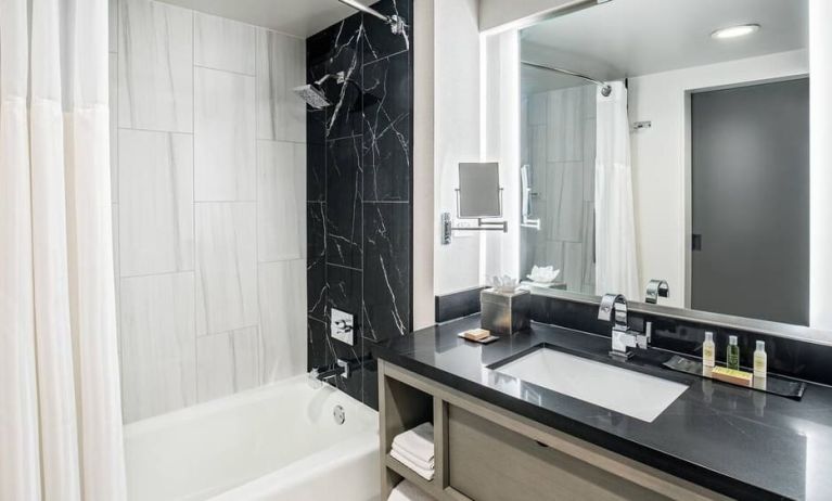 Private guest bathroom with shower and tub at DoubleTree By Hilton Washington DC North/Gaithersburg.