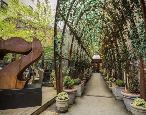 Vine covered trellis entryway leading to the lobby of the Nomo Soho in New York City.